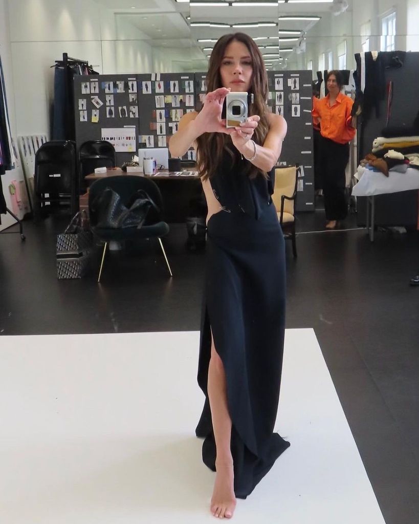 Victoria Beckham posing in a black dress