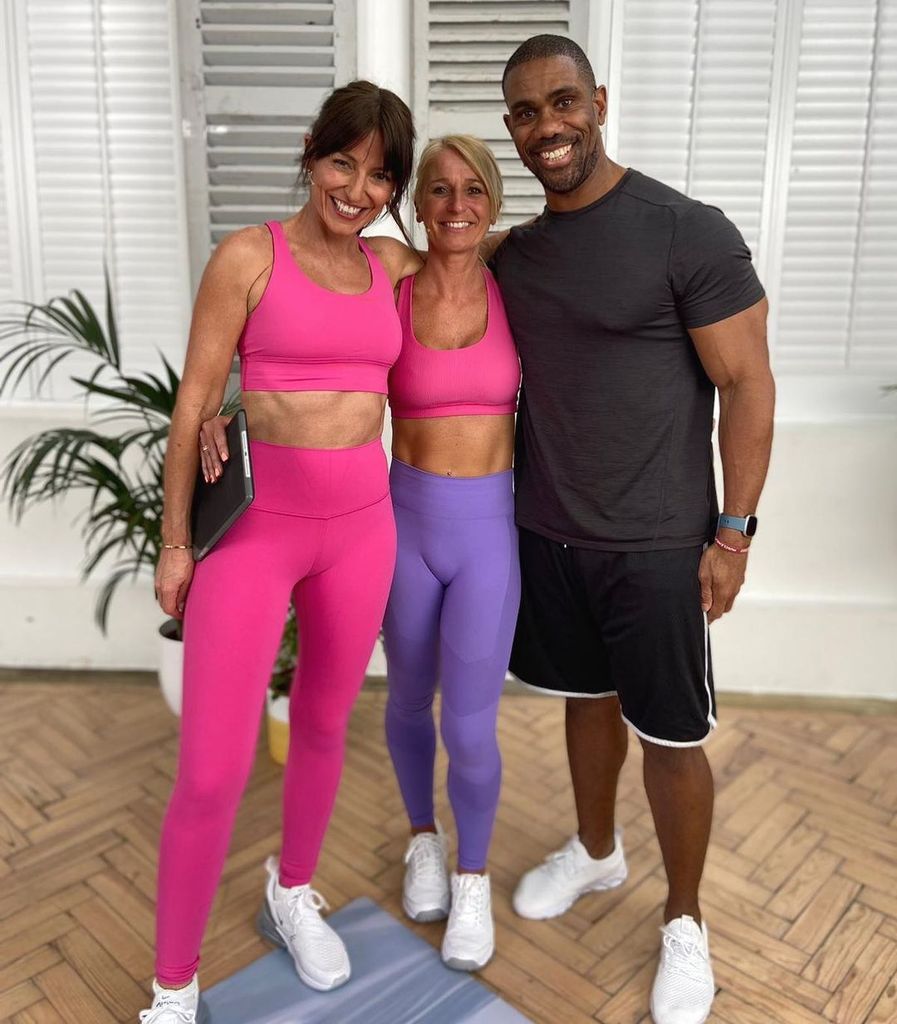 davina mccall in hot pink sports bra and leggings showing off abs