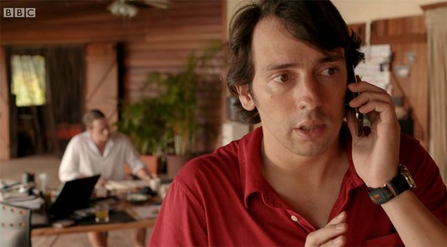 Ralf Little as Will Teague talks on phone in Death in paradise