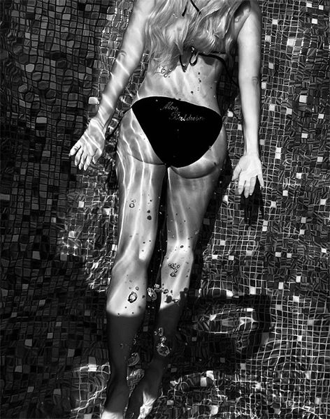 Holly Willoughby swimmig in black bikini