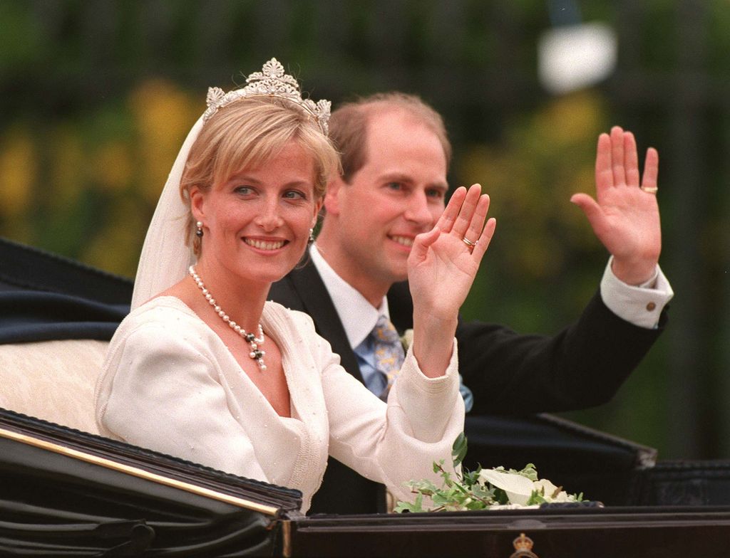 Prince Edward and Sophie wave to the crowd in carriage