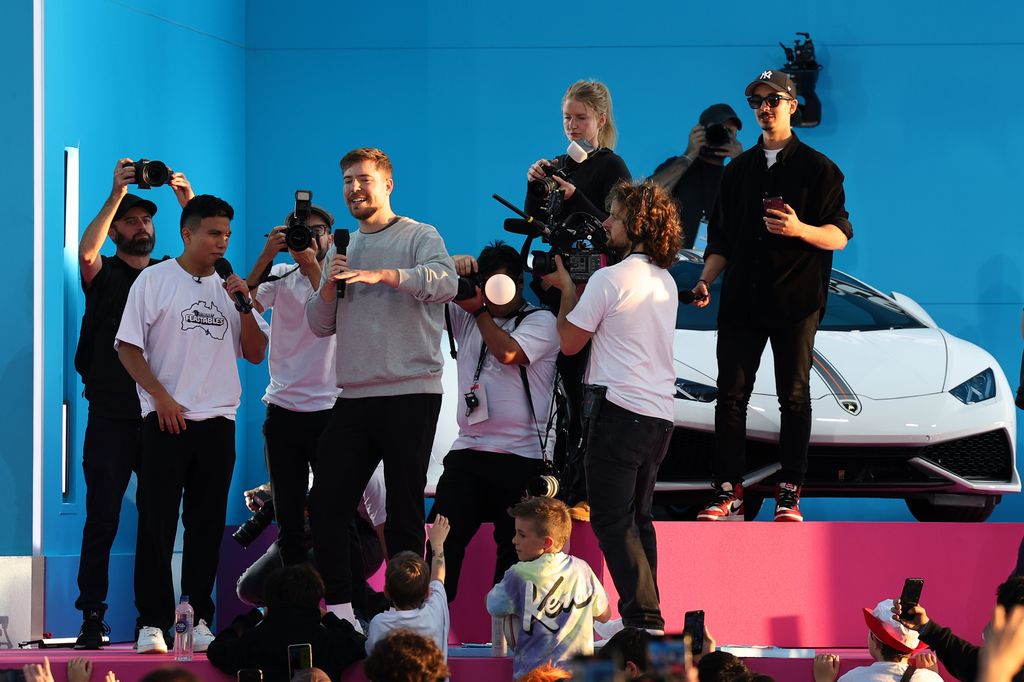 MrBeast onstage with the winning contestant during the MrBeast Feastables launch at Sydney Opera House