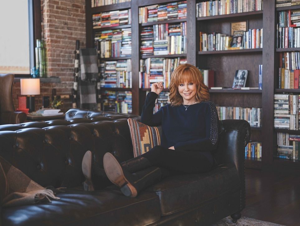 Reba McEntire lounges in a library