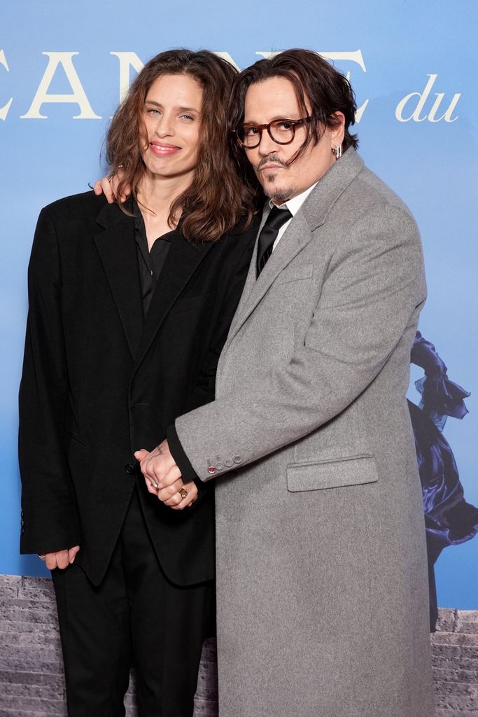 Maiwenn and Johnny Depp holding hands at premiere 