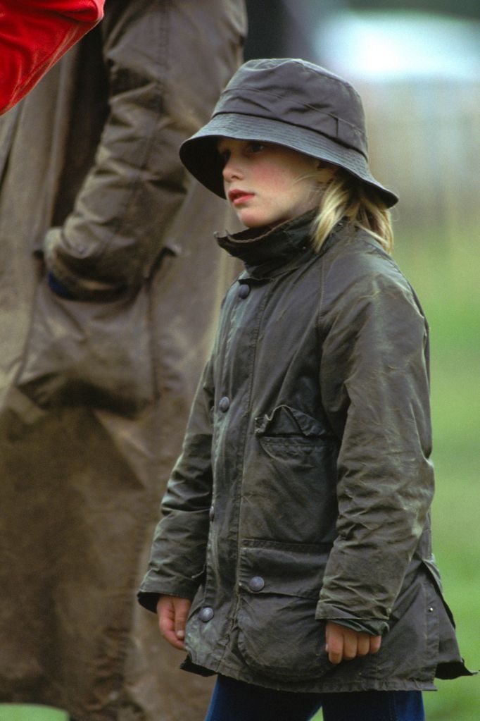 Zara Phillips At Royal Windsor Horse Show Wearing A Waxed Barbour Style Raincoat And Hat. 