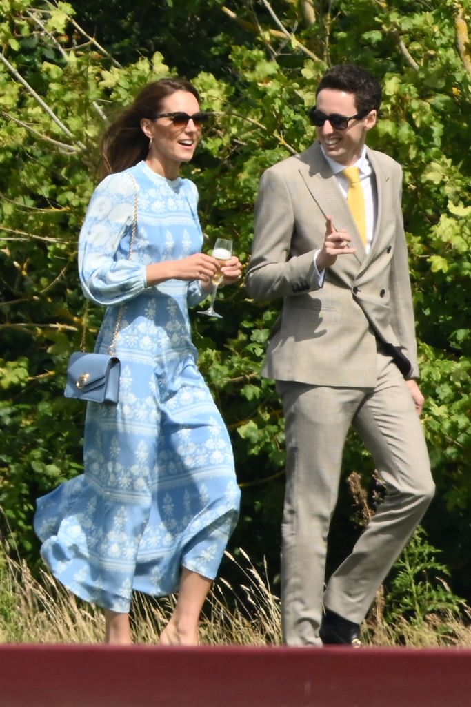 Kate accessorised with a blue leather bag