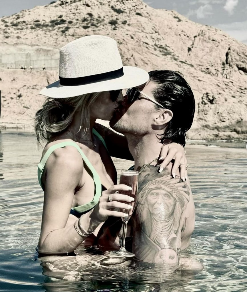 Photo shared by Josh Hall on Instagram March 2024 in which he is sharing a kiss with his wife Christina Hall at a beach in Cabo San Lucas