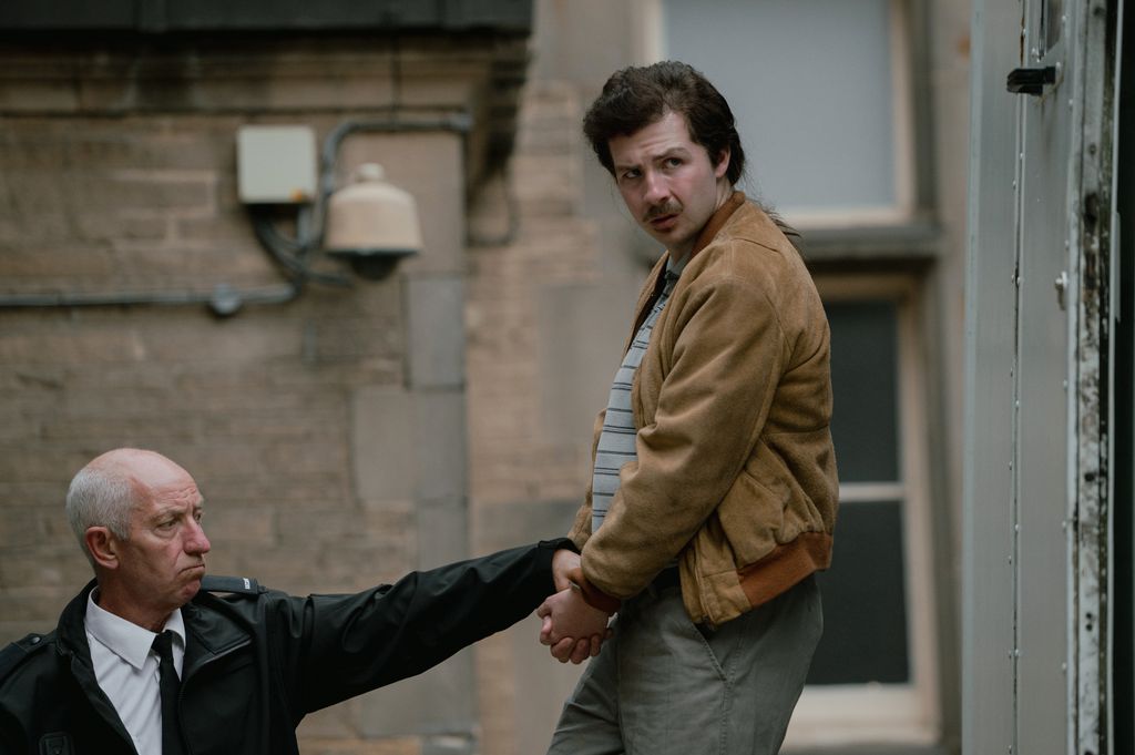 A man is taking away in handcuffs