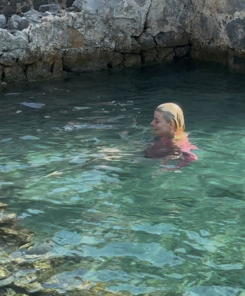 Anya Taylor-Joy in pink top while swimming in ocean
