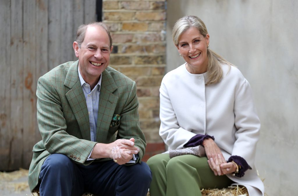 Prince Edward and Sophie smile sat on hay bail