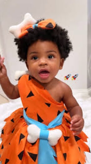 Lamar's daughter Milan dressed as Pebbles from the Flintstones