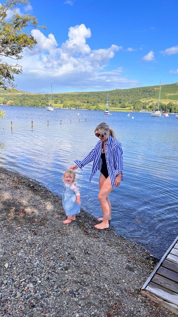 Helen Skelton and her daughter Elsie standing in a lake 
