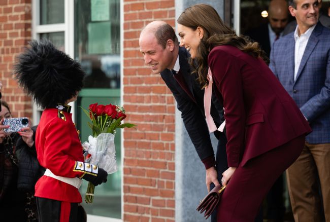 Kate and William meet a young boy dressed as Guard