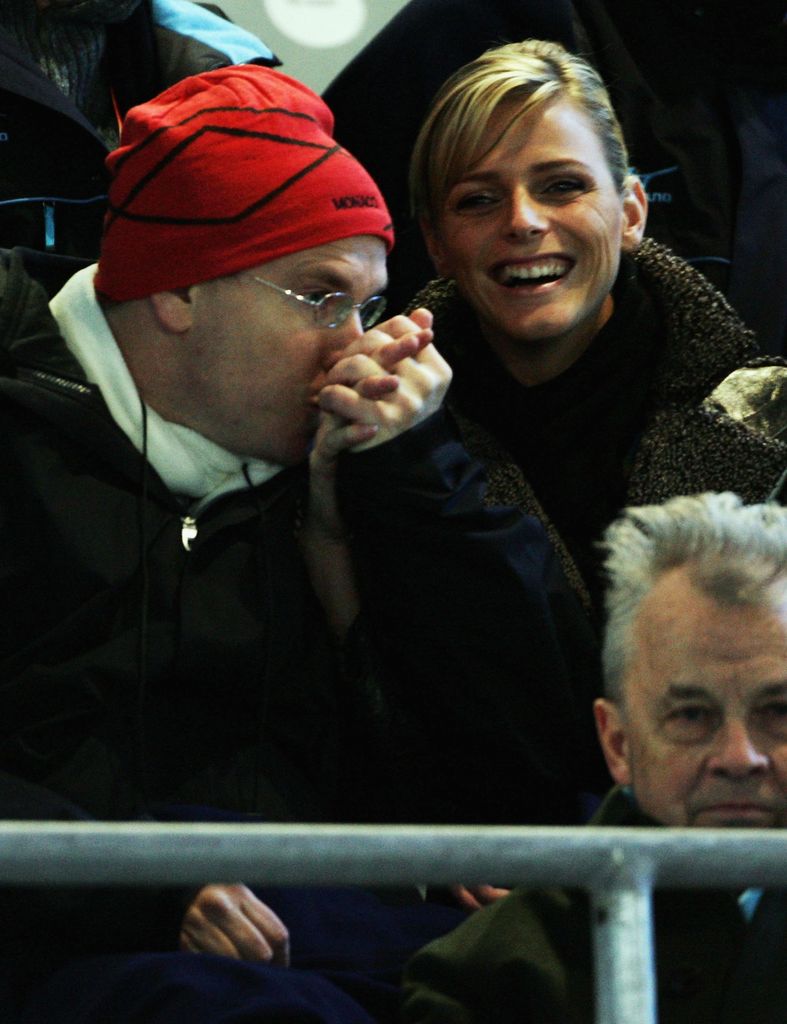 Prince Albert kissing Princess Charlene's hand