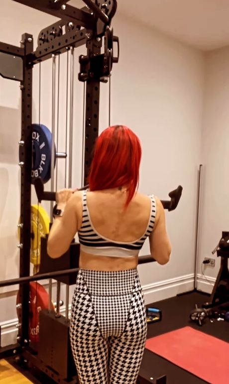 Dianne Buswell in the gym in a checkerboard outfit