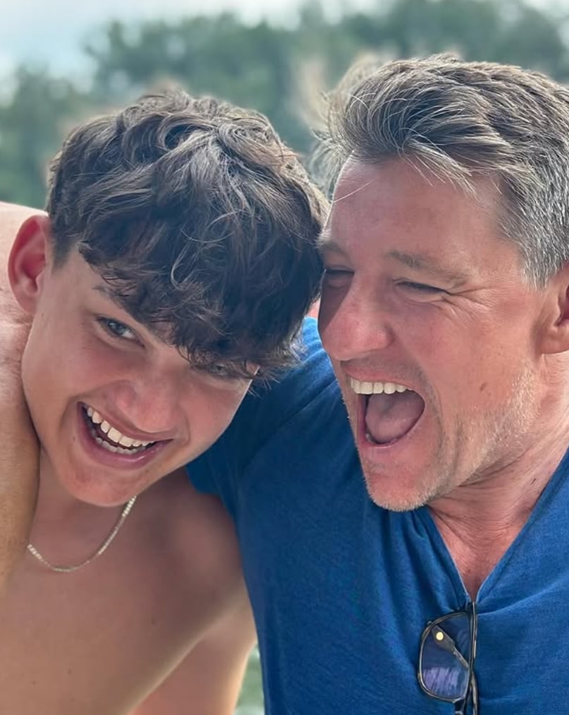 father laughing outside with lookalike son