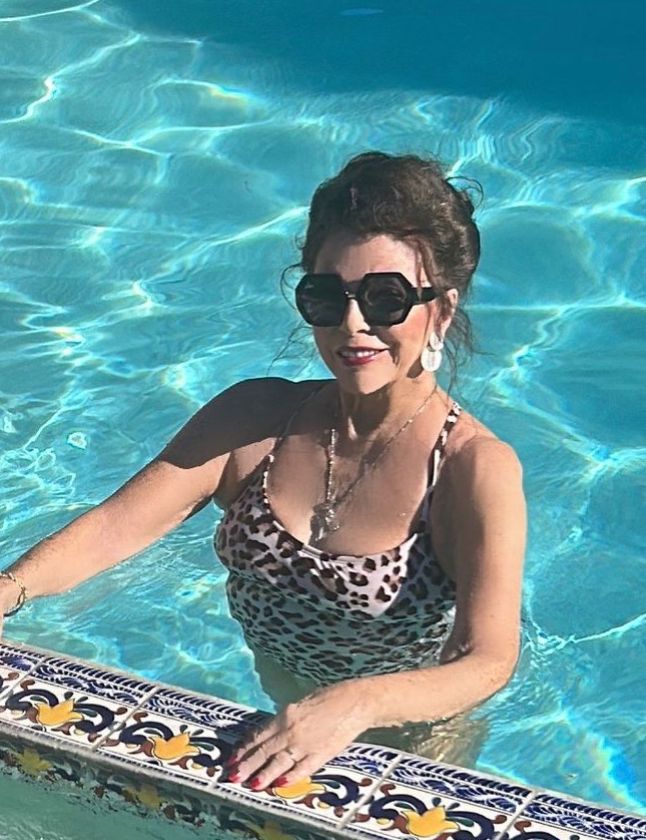 Joan Collins in an animal-print swimsuit