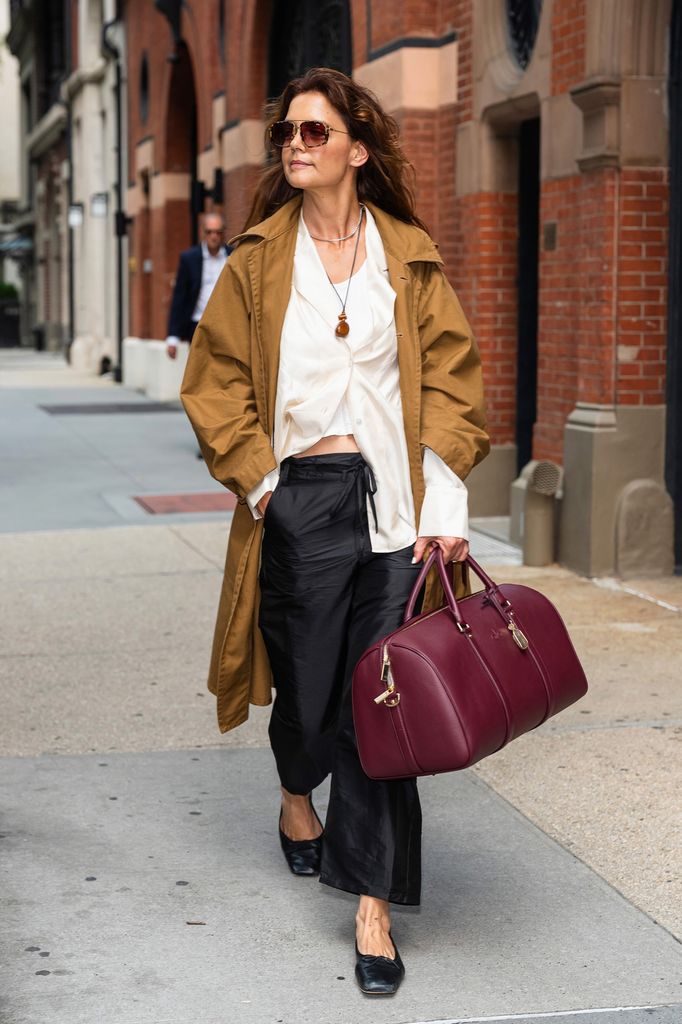 katie holmes in trench coat and red bag