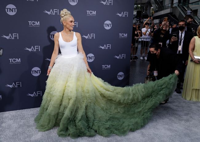 Gwen Stefani in a dramatic green and white dress on the red carpet