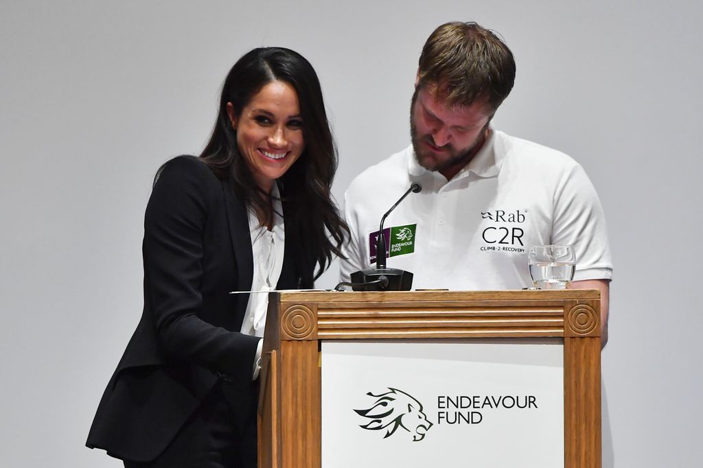Meghan Markle laughing on stage after realising the script mistake