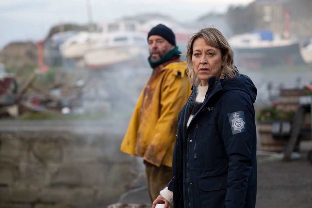 police officer standing next to man in yellow jacket