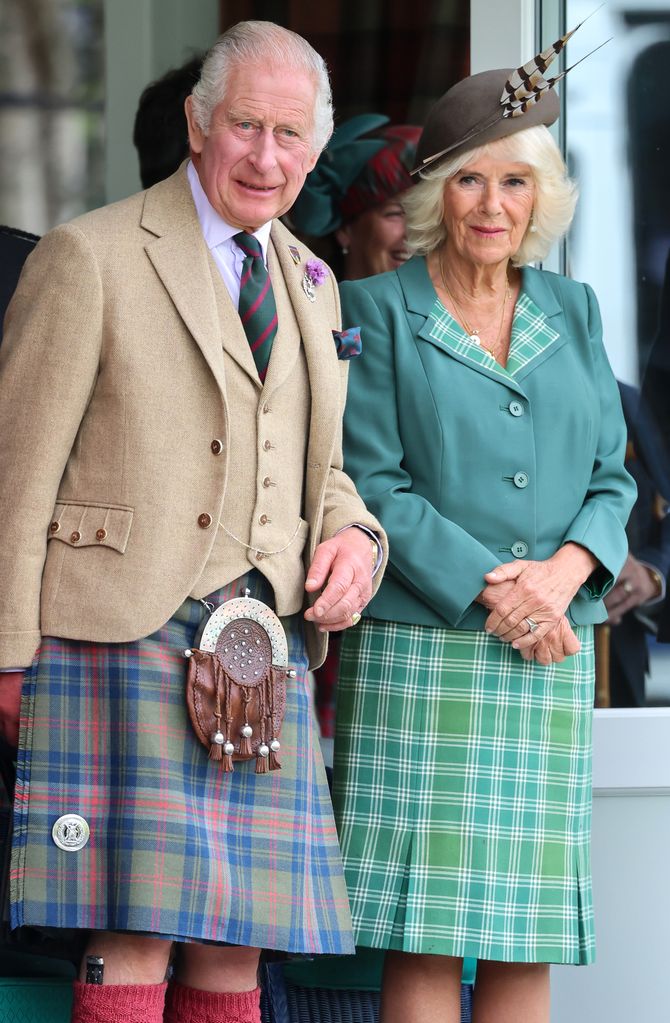 King Charles in a tartan kilt stood with Queen Camilla