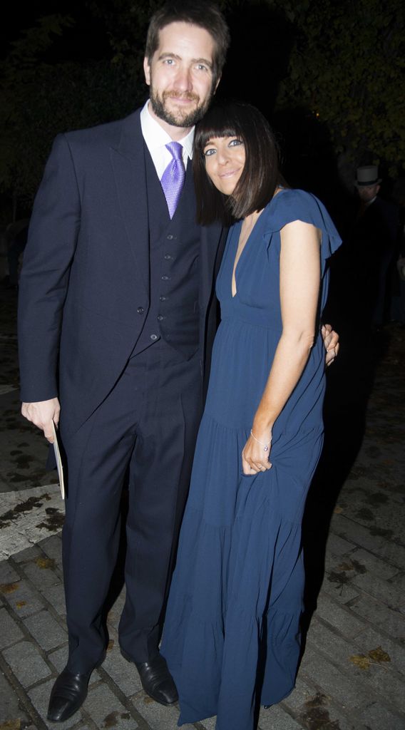 Claudia Winkleman in a blue dress with her husband