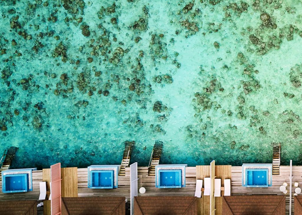 Drone shot of overwater pool villas at The Standard