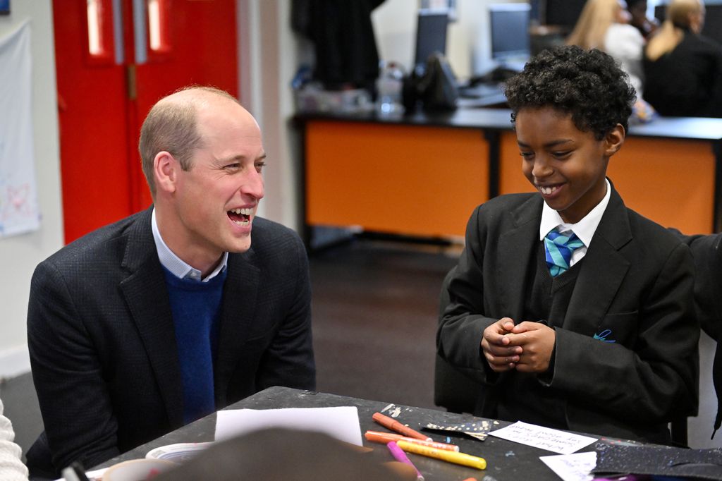 Prince William laughing with a young boy