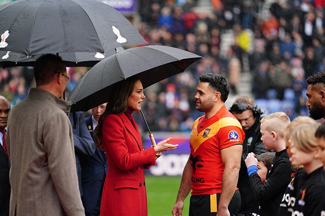 Kate Middleton speaking to a rugby player