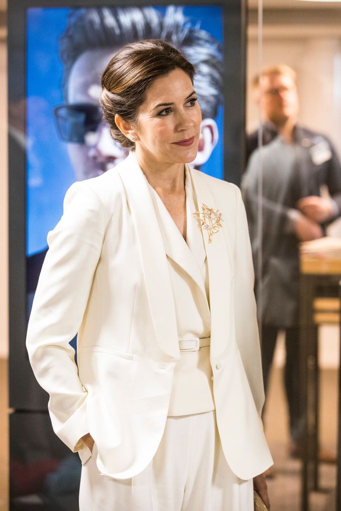 Crown Princess Mary of Denmark in a white suit with her hands in her pockets
