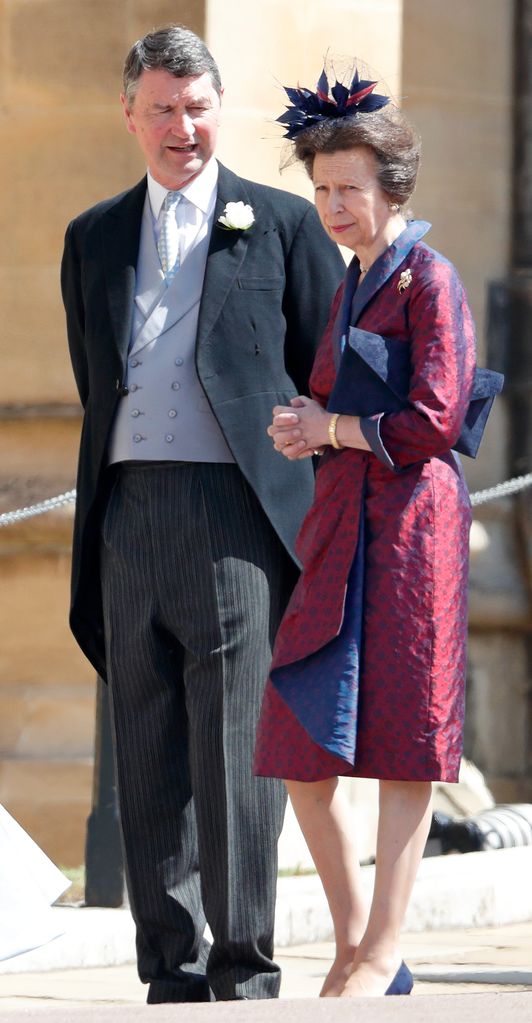 Princess Anne in a red and blue dress with her husband Tim 