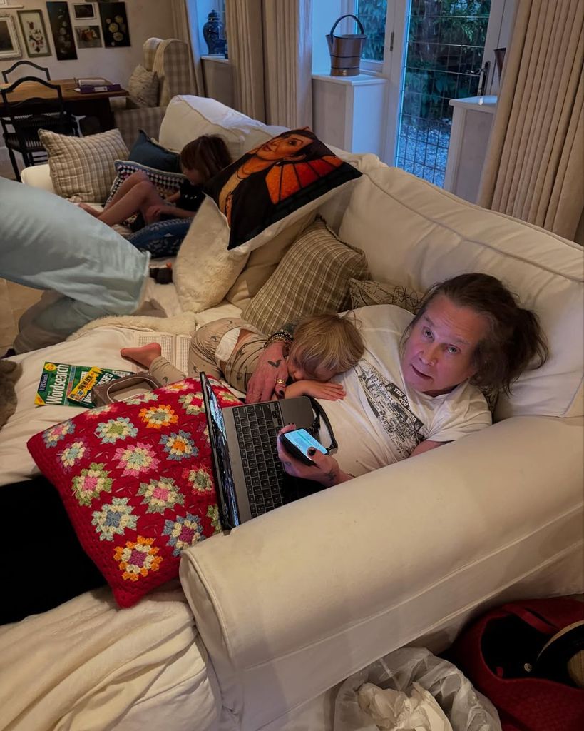 Ozzy Osbourne pictured lounging on a couch with one of his grandkids, shared on Instagram