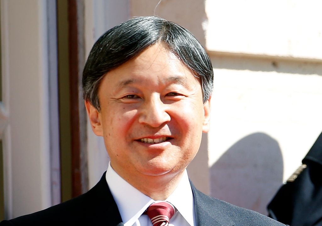 Emperor Naruhito smiling in a suit and tie