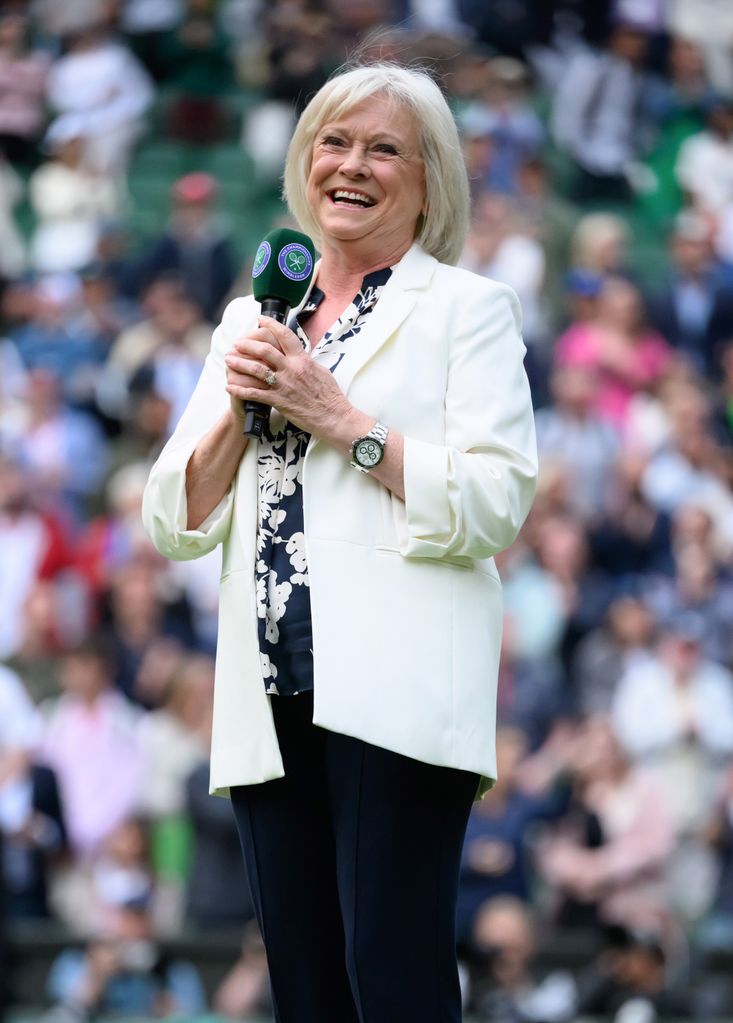 Sue Barker holds microphone at wimbledon