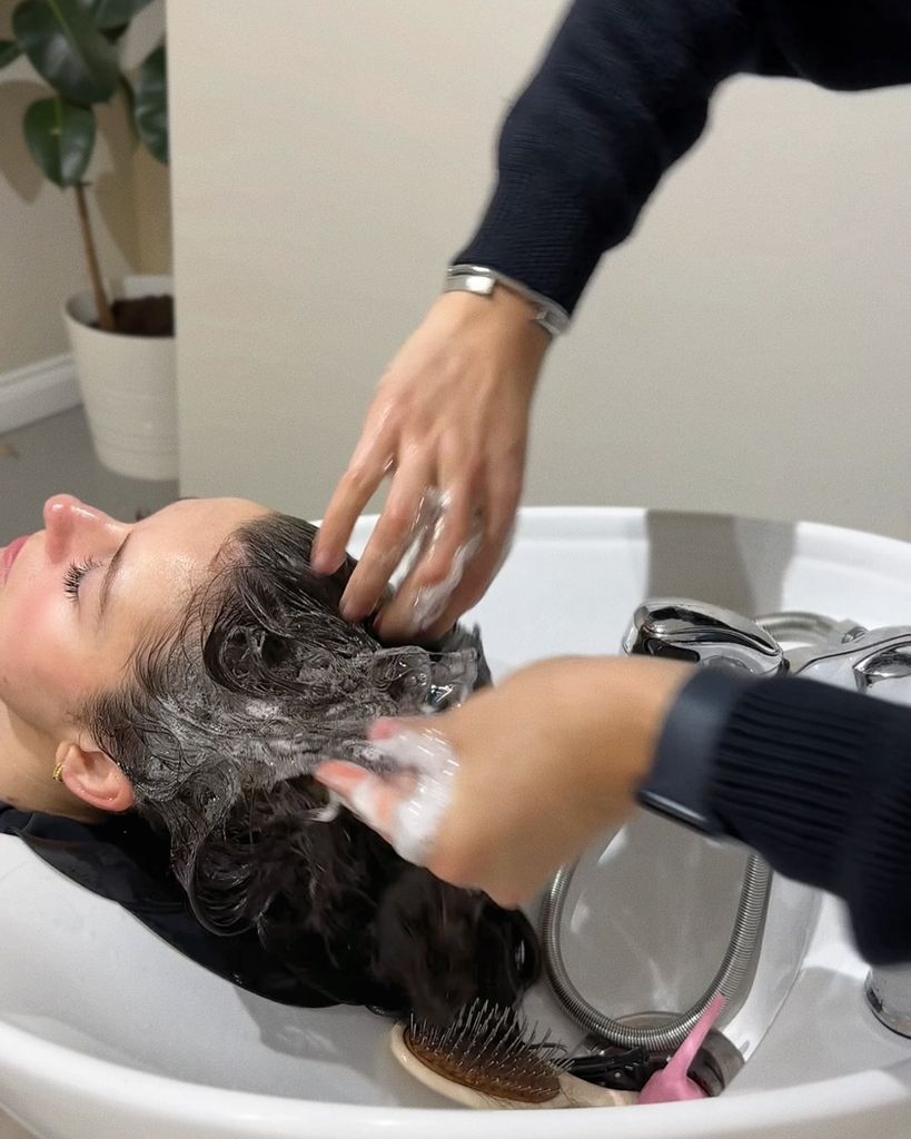 person having their hair washed in a basin at at hair dressing salon
