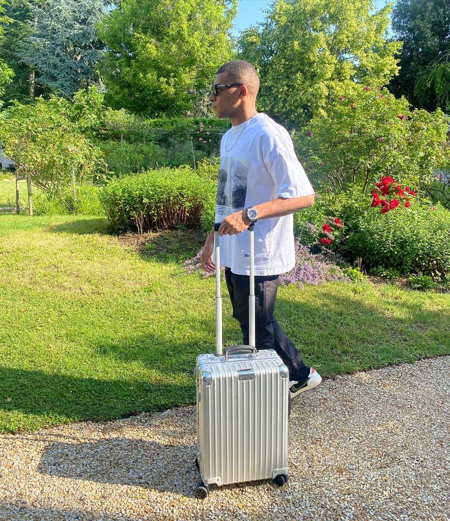 man walking with silver suitcase