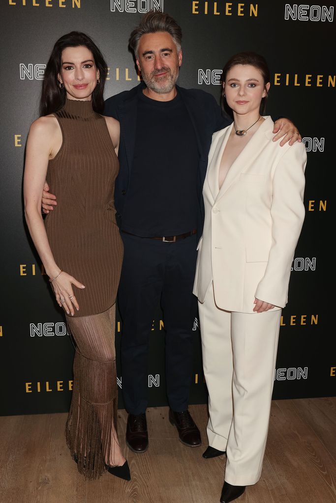 Anne Hathaway with 'Eileen' director, William Oldroyd, and co-star Thomasin McKenzie