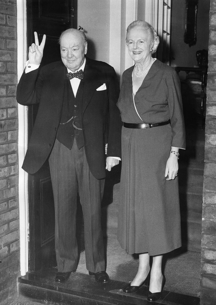 Winston Churchill pulling a peace sign with his wife Clementine