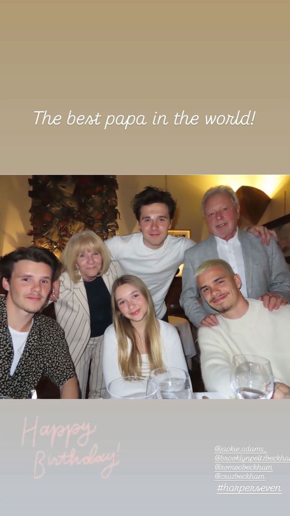 family posing for photo around dining table