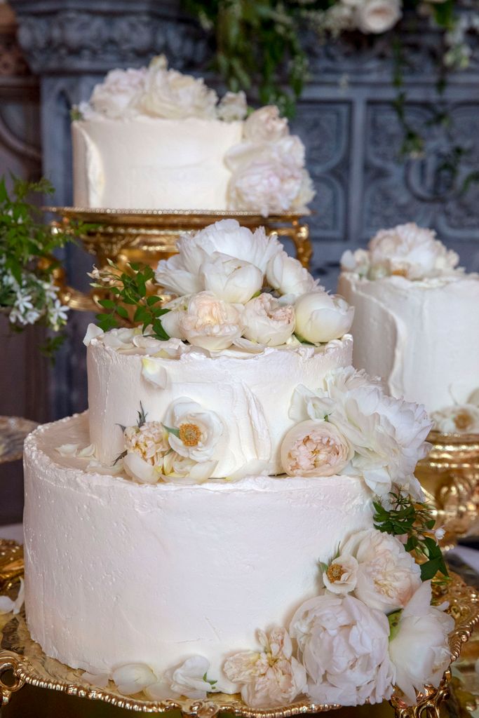 wedding cake covered in fresh flowers 
