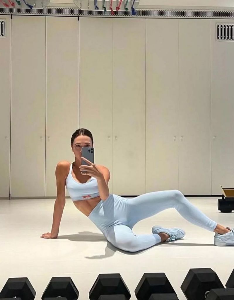 Victoria Beckham wears a pale blue workout top and leggings