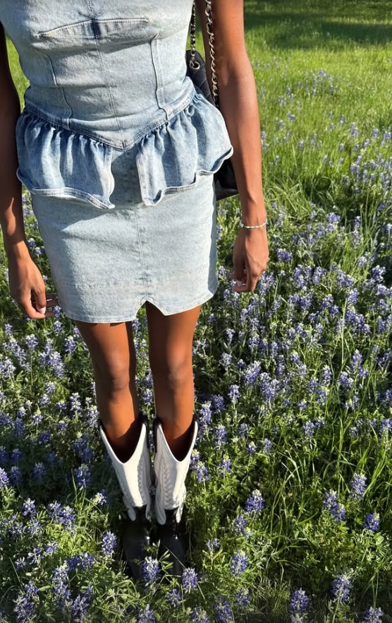 simone ashley in a light wash denim dress