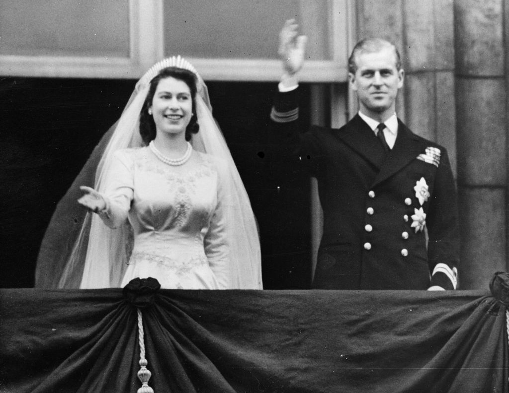 The Queen and Prince Philip waving from Buckingham Palace on their wedding day