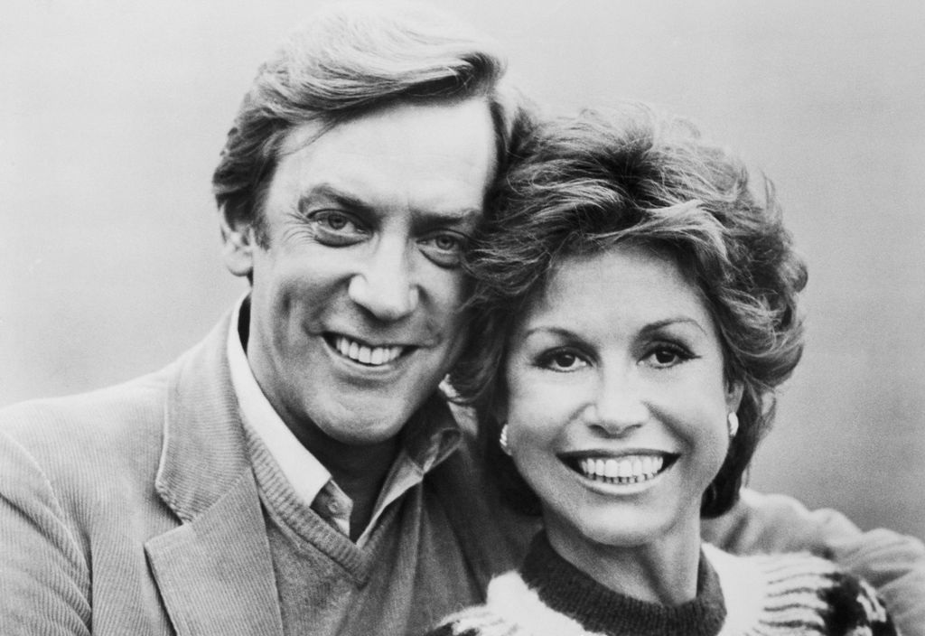Donald Sutherland and Mary Tyler Moore are shown in a scene from their movie, Ordinary People directed by Robert Redford and released by Paramount Pictures. They are shown conversing closely to each other. Sutherland and Moore attempt to pick up the pieces of their shattered life after a major tragedy by planning a holiday trip to London in this Paramount Picture's release, a Wildwood Enterprises Production.