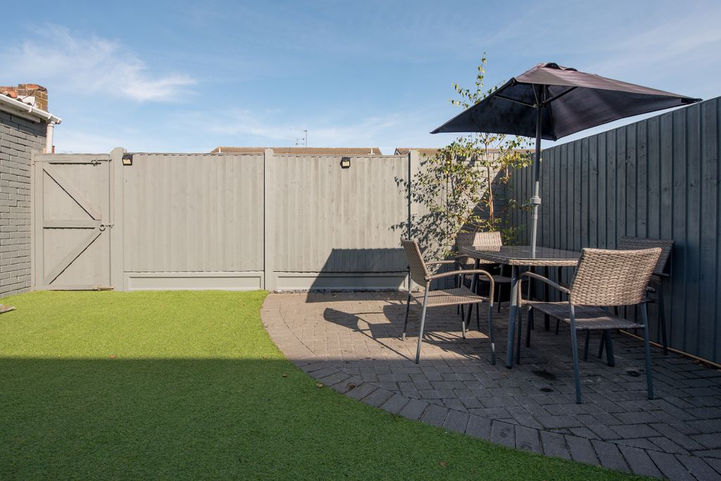 garden with grass, patio and fence