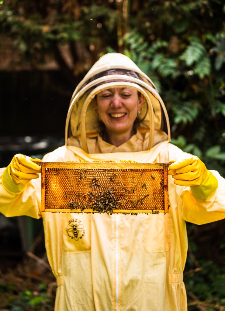 Woman smiling holding bees
