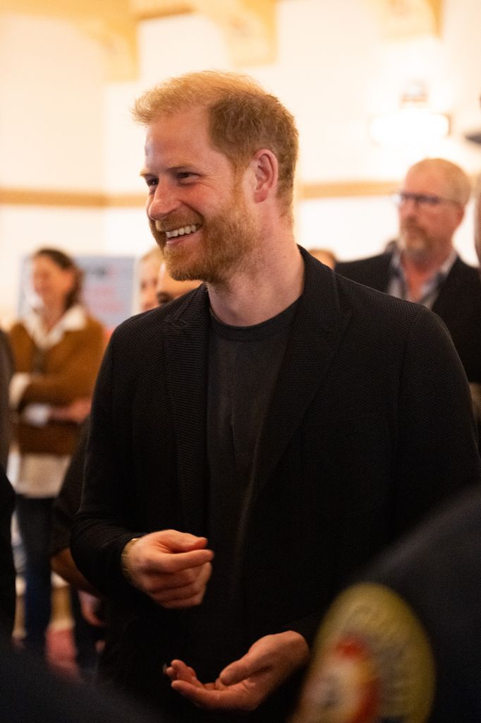 prince harry smiling in dark suit 