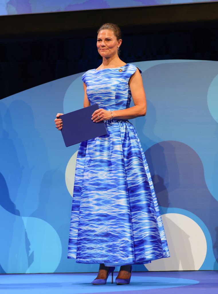 Crown Princess Victoria on stage in blue dress