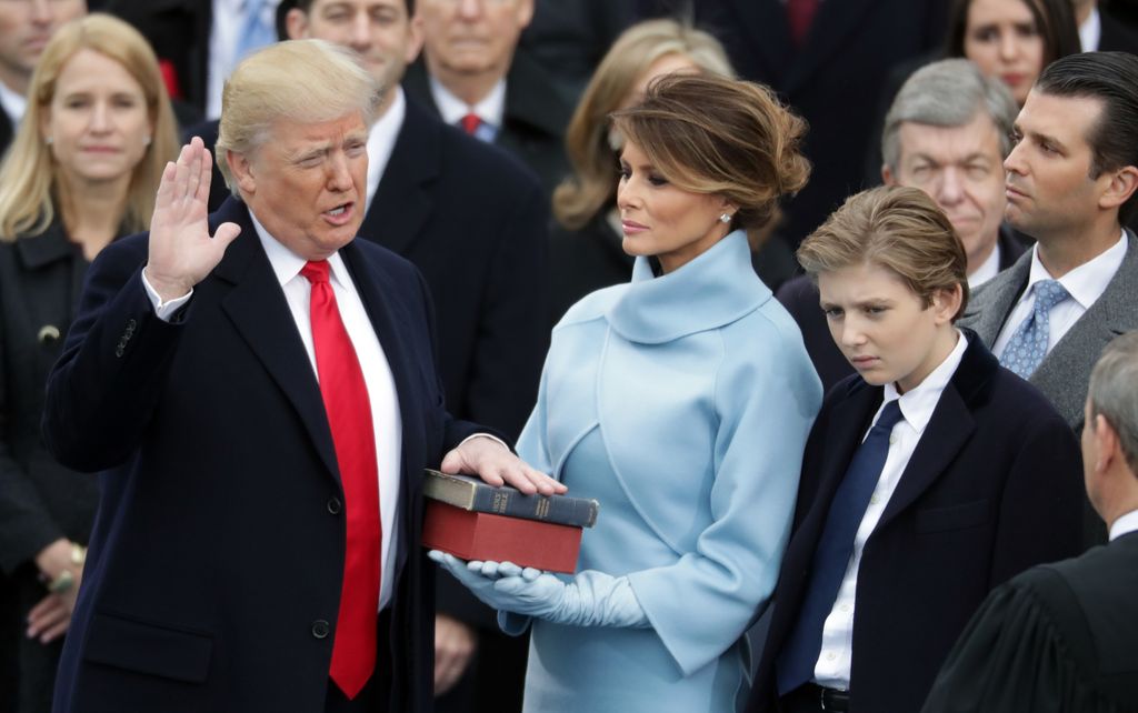 U.S. President Donald Trump takes the oath of office as his wife Melania Trump holds the bible and his son Barron Trump looks on, on the West Front of the U.S. Capitol on January 20, 2017 in Washington, DC. In today's inauguration ceremony Donald J. Trump becomes the 45th president of the United States